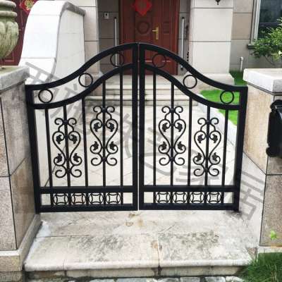 A small iron gate in the courtyard of a residential villa